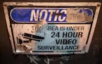 A worn surveillance sign hangs on a building on 14th Avenue SE in the Dinkytown neighborhood of Minneapolis in 2021. Concern about crime in the area h