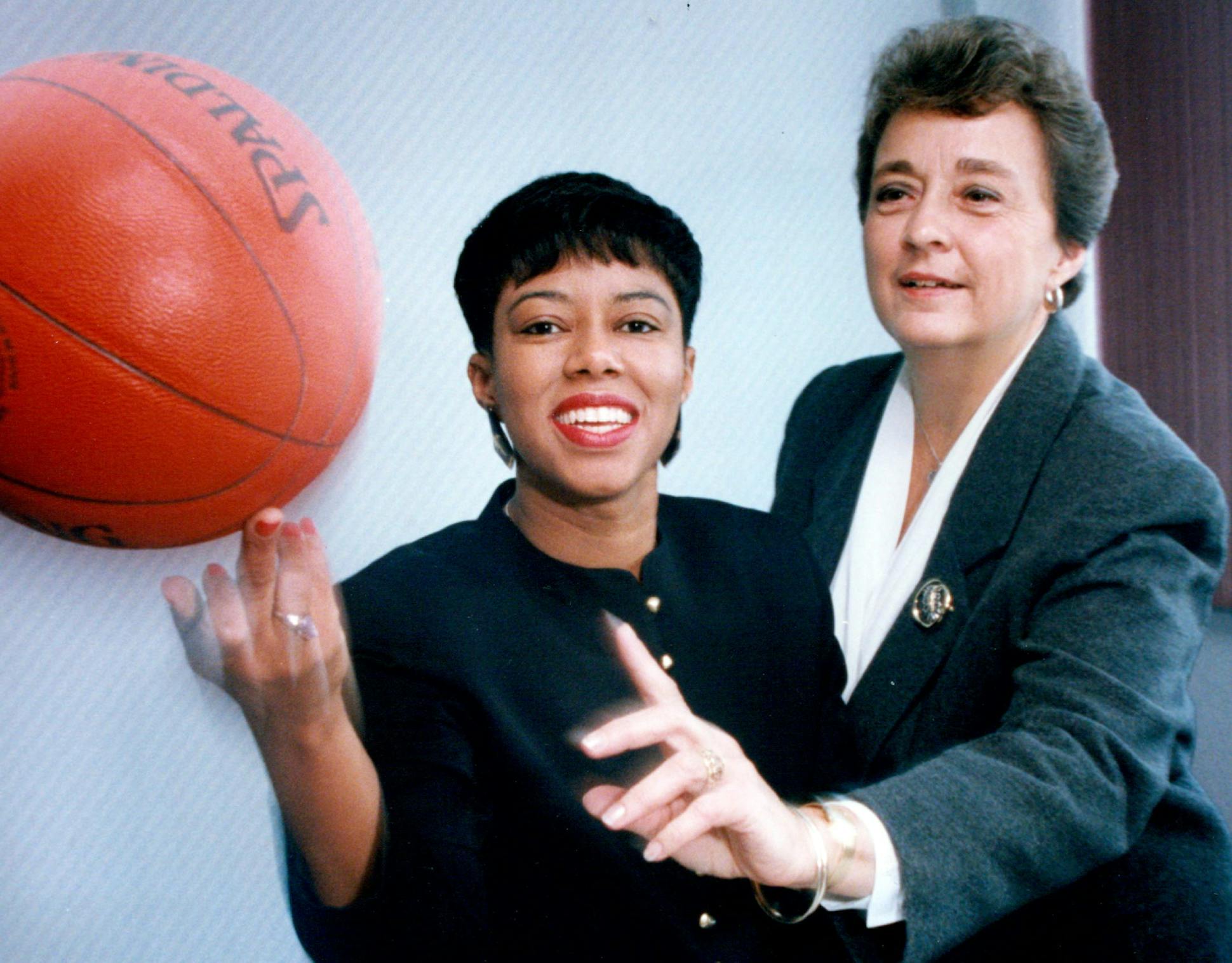 Associate directors of the Minnesota State High School league for Women's Sports Day. Lisa Lissimore (left) and Dorothy McIntyre (right) trying to pass a spinning basketball.