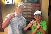 Ricardo Fernandez and 13-year-old Preston Miller held the ball they both used for an ace Thursday at Minneapolis Golf Club.