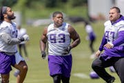 Vikings defensive tackle Jaylen Twyman (93) warms up on the field with teammates at the TCO Performance Center in Eagan this month.