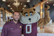 Gophers men’s basketball coach Ben Johnson posed with mascot Goldy Gopher in Stillwater on Monday night.
