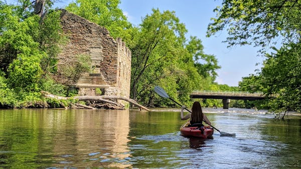 Paddling the upper Cannon River past mill ruins in Dundas, Minn.