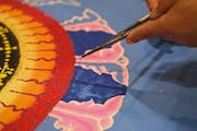 In Buddhist teachings, the concept of “near enemies” is a subtle way of understanding risk. File photo of a Buddhist mandala artist.