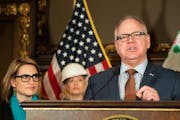 Gov. Tim Walz, at a 2019 press conference on energy and climate policy, has signed a letter urging Congress to take action.