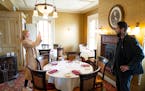 Amanda Zielike and David Decker take photos inside an 1870 Victorian mansion that housed Forepaugh’s Restaurant for 42 years in St. Paul. The couple