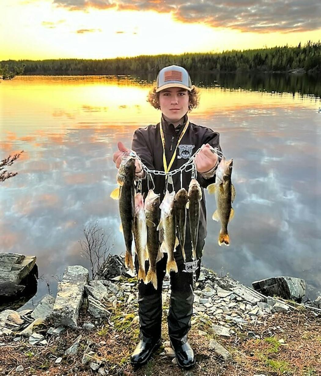 Joe Kennedy, 15, of Cottage Grove, with a stringer of walleyes caught by he and his dad on the first afternoon and evening of their trip to Ensign Lake. The fish were fried for dinner the next night for a group of five.