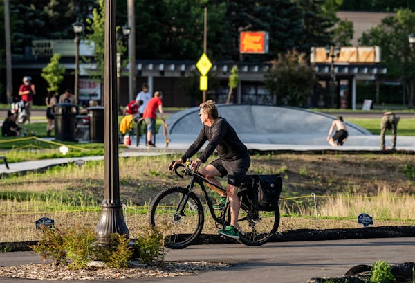 A biker watched skaters enjoy Gateway Park after temperatures dipped Tuesday night in St. Paul. After years of planning and building, the park at St. 