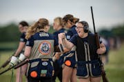 Cora Gross, of Walker-Hackensack Akeley High school fist bumped a teammate during competition in the Class-3A-Trap match up at the Alexandria Shooting
