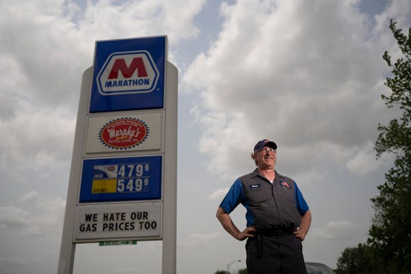 Murphy’s Service Center owner Chuck Graff with the sign he put up at his St. Anthony gas station. Profit margins are very narrow for gas station own