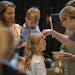 Pastor Sara Wilhem Garbers blessed Fiona Watson while Erin Watson held son Julian during a baptism ceremony at Meetinghouse Church in Edina on June 12