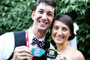 At their August 2013 wedding, Peter Schmitt and Katie Jones of Minneapolis held the German name tags Jones made for them after they met at Concordia L