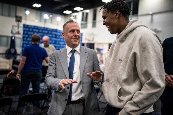 Timberwolves President Tim Connelly, left, at his introductory press conference on May 31 with Wolves forward Nathan Knight. 
