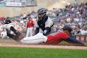Minnesota Twins' Byron Buxton beats the tag by New York Yankees catcher Jose Trevino to score from third base on a sacrifice fly by Max Kepler during 