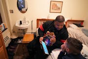Shuntay Thomas and son Brandon, 10, listened to music at the Project Home at the Provincial House in St. Paul in December. The building used to house 