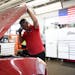 Operations Leader Gary DeRusha checks under the hood of a Nissan SUV before testing the battery Wednesday, June 22, 2022 at Bobby and Steve’s Auto W