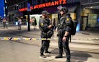 Police stood guard outside a bar in central Oslo, early Saturday, June 25, 2022. Norwegian police say a few people have been killed and more than a do