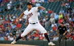 Twins pitcher Chris Archer throws against the Colorado Rockies during the first inning Saturday