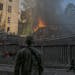Firefighters and soldiers respond at the site of a Russian missile strike in central Kyiv, Ukraine on Sunday, June 26, 2022. 