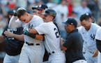 Yankees star Aaron Judge (99) was greeted by teammates after hitting a winning home run against the Astros during the 10th inning Sunday.