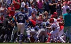 Several members of the Mariners and the Angels scuffled Sunday after Seattle’s Jesse Winker was hit by a pitch during the second inning.
