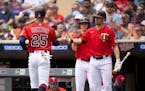 Minnesota Twins designated hitter Byron Buxton (25) was congratulated by Alex Kirilloff after he scored on a first inning single by Max Kepler Sunday 
