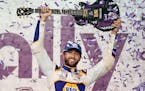 Chase Elliott held up the guitar presented to him after winning Sunday night’s NASCAR race in Lebanon, Tenn.