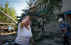 A woman reacts after the Russian shelling in city center in Slavyansk, Donetsk region, Ukraine, Monday, June 27, 2022. 