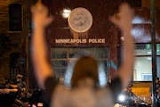 Protesters stood across from officers at the Minneapolis 3rd Police Precinct on May 26, 2020.