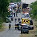 Police work the scene where dozens of people were found dead in a semitrailer in a remote area in southwestern San Antonio, Monday, June 27, 2022. 