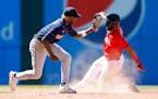 Minnesota Twins second baseman Nick Gordon, left, tags out Cleveland Guardians’ Amed Rosario attempting to steal second base during the eighth innin