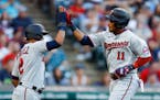 Jorge Polanco celebrates with Luis Arraez after hitting a two-run home run against the Guardians during the third inning 