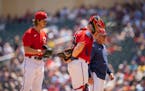 Twins pitching coach Wes Johnson walked with catcher Ryan Jeffers  after visiting Twins starting pitcher Joe Ryan on the mound in the second inning Su
