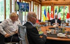 President Volodymyr Zelenskyy of Ukraine appears on a video screen as he meets remotely from an undisclosed location with G-7 leaders in Kruen, German