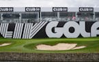 Signage near the 18th green before the first round of the inaugural LIV Golf Invitational at the Centurion Club in St. Albans, England,