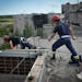 Ukrainian rescuers dismantle the roof of a high-rise building damaged by Russian shelling in one of the residential areas of Kharkiv, Ukraine, Thursda