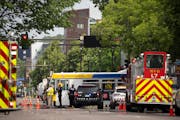 Emergency personnel on a closed University Ave. Thursday afternoon in Minneapolis after a suspected gas leak on SE. University Avenue and a fire at a 