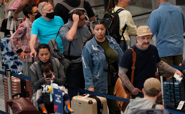 Travelers waited in the ticketing line at Minneapolis-St. Paul International Airport in May.