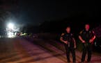 Police guard an area at the scene where a tractor-trailer was discovered with migrants inside-outside San Antonio, Texas on June 27, 2022. 