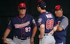 Twins coaches Stu Cliburn (93), Pete Maki (88) and Wes Johnson conferred during spring training in 2019.
