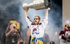 Avalanche left wing Gabriel Landeskog lifts the Stranley Cup during a rally after a parade through the streets of downtown Denver