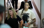 WNBA star and two-time Olympic gold medalist Brittney Griner is escorted to a courtroom for a hearing, in Khimki just outside Moscow, Russia, Friday, 