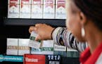 A worker places low-nicotine cigarettes on a shelf at a Circle K store in Chicago on June 21, 2022. The Food and Drug Administration is planning to re