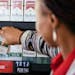 A worker places low-nicotine cigarettes on a shelf at a Circle K store in Chicago on June 21, 2022. The Food and Drug Administration is planning to re