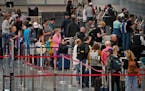 Air travelers waited in line at ticketing in terminal 1 at Minneapolis-St. Paul International Airport during the start of the busy July 4th holiday tr