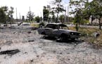 In this photo provided by the Luhansk region military administration, burned car and damaged residential buildings are seen in Lysychansk, Luhansk reg