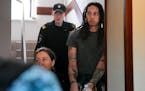 WNBA star and two-time Olympic gold medalist Brittney Griner is escorted to a courtroom for a hearing, in Khimki just outside Moscow, Russia, Monday, 