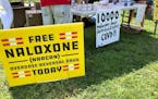Signs are displayed at a tent during a health event on June 26, 2021, in Charleston, W.Va. A federal judge on Monday, July 4, ruled in favor of three 