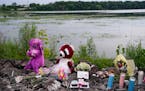 A memorial sits on the edge of Vadnais Lake on Monday, July 4, in Vadnais Heights. The bodies of three children under the age of 6 and their mother we