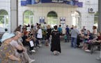Residents of Donetsk stand in line at a Migration Service office to receive a passport of a citizen of the Russian Federation, in Donetsk, in an area 
