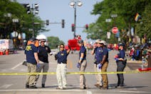 Law enforcement and members of the FBI evidence response team gathered data Tuesday along Central Avenue after Monday’s mass shooting in Highland Pa